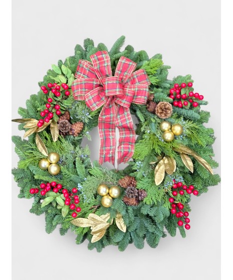 This traditional Christmas wreath is a timeless holiday decoration crafted from lush, fragrant evergreen branches.