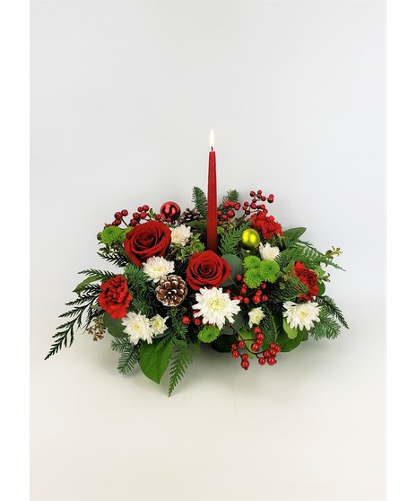 Double candle centerpiece featuring red roses, tartan ribbon, and other festive flowers. 