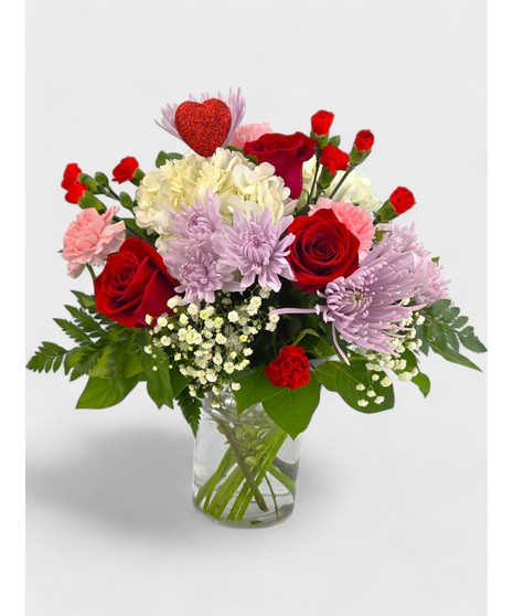 This mix of red roses, mums, carnations, stock, and assorted fillers is accented by a sparkling red heart.  A perfect gift for your Valentine!