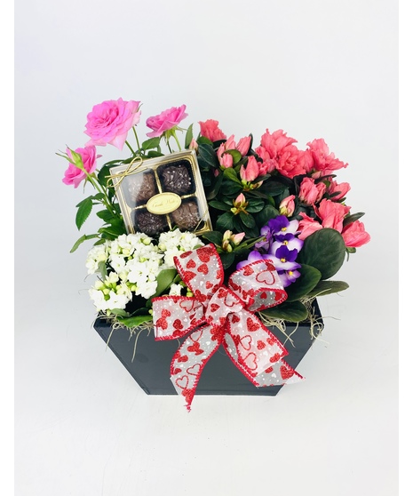 A black wooden box with bright blooming plants and handmade Sea Salt Caramels will leave a lasting impression. 