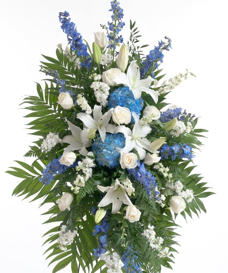 Mix of roses, delphinium, hydrangea and other accenting flowers in blue and white. Displayed on an easel creating a big impression in any sized room.