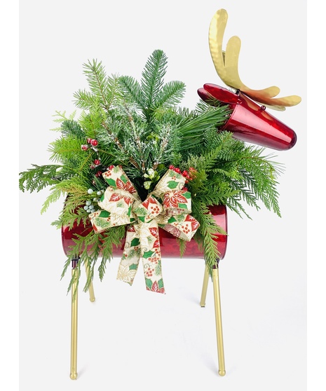 Freshly cut evergreens and berries displayed in a galvanized metal reindeer planter. This planter is the perfect addition to any front porch! 