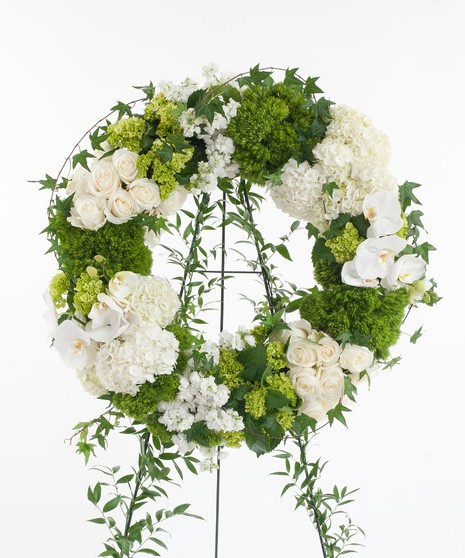 White orchids, Calla lilies, hydrangea, roses, and other premium accents. Wreath display features  the finest white flowers available. 