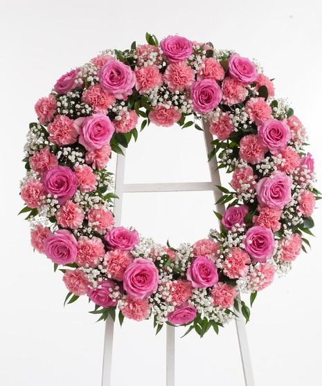 Wreath display featuring stunning pink roses and pink carnations.Approximate size of the standard design is 18