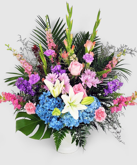 Pastel Compassion. Hydrangea, roses, snap dragons and the most fresh seasonal flowers combine to express your most sincere feelings. Pastel pinks, lavenders, white and blue.