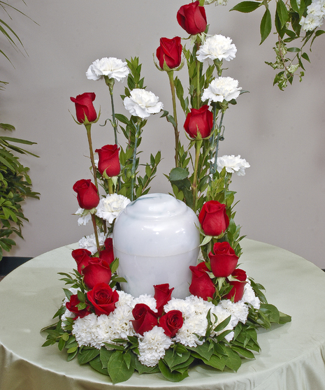 Red Roses and White Carnations beautifully display an urn in a traditional red and white theme. Approximate size of standard design is 18