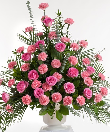 Classic mix or roses and carnations in shades of pink artfully designed in a white container. Approximate size for the standard design is 24