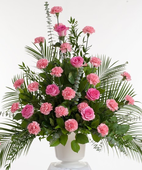 Classic mix or roses and carnations in shades of pink artfully designed in a white container. Approximate size for the standard design is 24