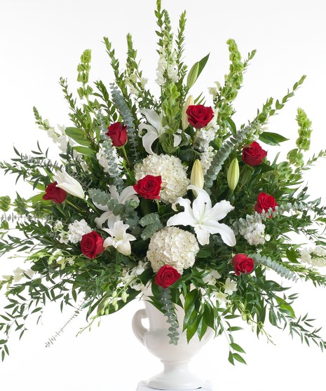 Stunning mix of red roses and white lilies designed in a white container. Approximate size for the standard design is 20