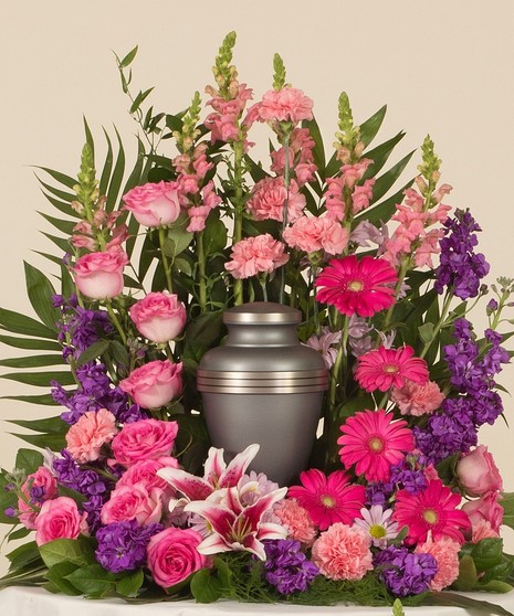 Perfect mix of roses, lilies, and daisy's in striking shades of pinks and purples. This design is perfect for and urn placement at a memorial service. 