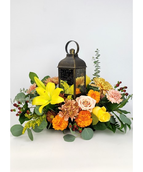 Show them how much you care with this warm gift. Yellow, orange and rustic fall accents designed with lily, roses and mums.